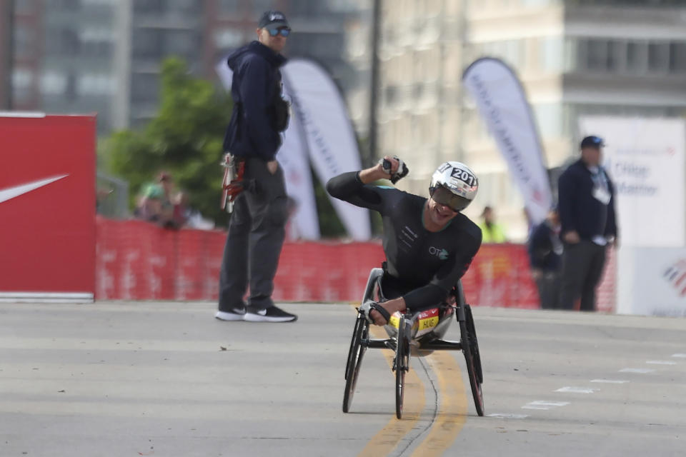 Marcel Hug celebrates his Chicago Marathon course record victory, in Chicago's Grant Park on Sunday, Oct. 8, 2023. (Eileen T. Meslar /Chicago Tribune via AP)