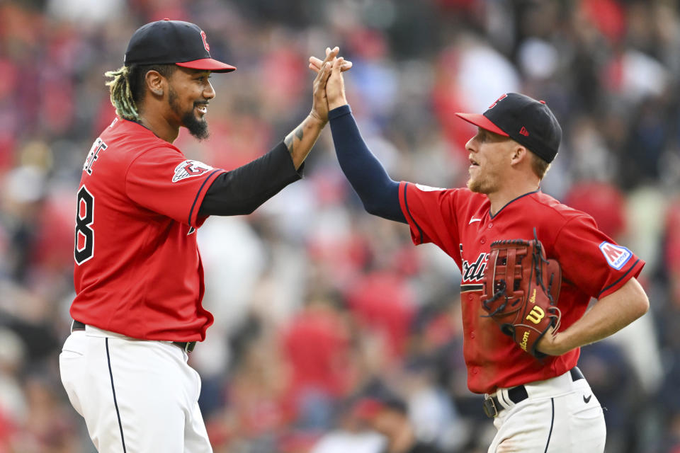 Cleveland Guardians relief pitcher Emmanuel Clase, left, and Myles Straw celebrate after their win over the Kansas City Royals in a baseball game, Saturday, July 8, 2023, in Cleveland. (AP Photo/Nick Cammett)