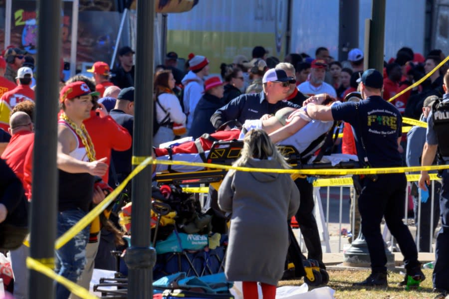A woman is taken to an ambulance after an incident following the Kansa City Chiefs NFL football Super Bowl celebration in Kansas City, Mo., Wednesday, Feb. 14, 2024. The Chiefs defeated the San Francisco 49ers Sunday in the Super Bowl 58. (AP Photo/Reed Hoffmann)