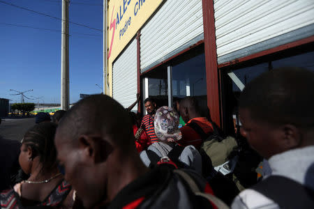 Haitian migrants ask for an opportunity to sleep outside Padre Chava shelter after leaving Brazil, where they sought refuge after Haiti's 2010 earthquake, but are now attempting to enter the U.S., in Tijuana, Mexico, October 3, 2016. REUTERS/Edgard Garrido