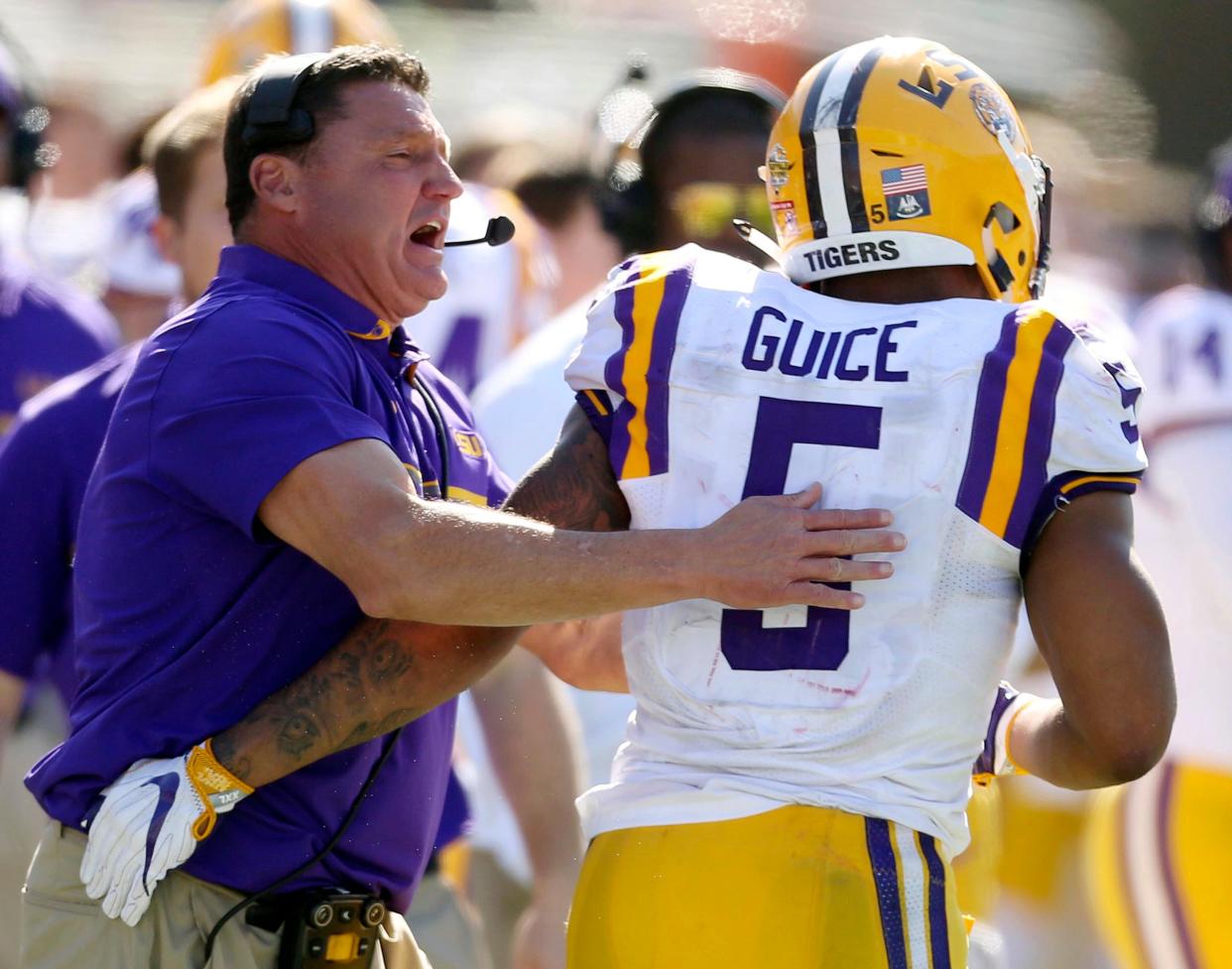 LSU head coach Ed Orgeron celebrates with running back Derrius Guice (5) after a touchdown against Louisville during the first half of the Citrus Bowl NCAA football game, Saturday, Dec. 31, 2016, in Orlando, Fla. (Stephen M. Dowell/Orlando Sentinel via AP)