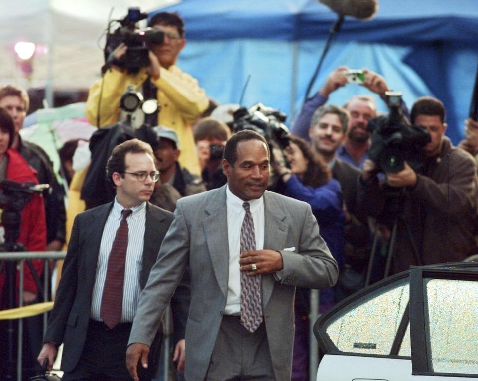 FILE - O.J. Simpson and his defense attorney Daniel Leonard leave Los Angeles County Superior court in Santa Monica, Calif., Friday, Nov. 22, 1996, after testifying in the wrongful death civil trial against him. Simpson, the decorated football superstar and Hollywood actor who was acquitted of charges he killed his former wife and her friend but later found liable in a separate civil trial, has died. He was 76. (AP Photo/Michael Caulfield, File)