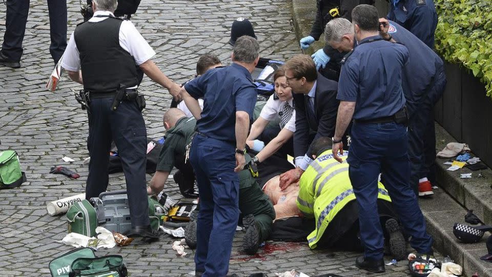 Paramedics working to resuscitate a man on Westminster Bridge. Photo: AAP