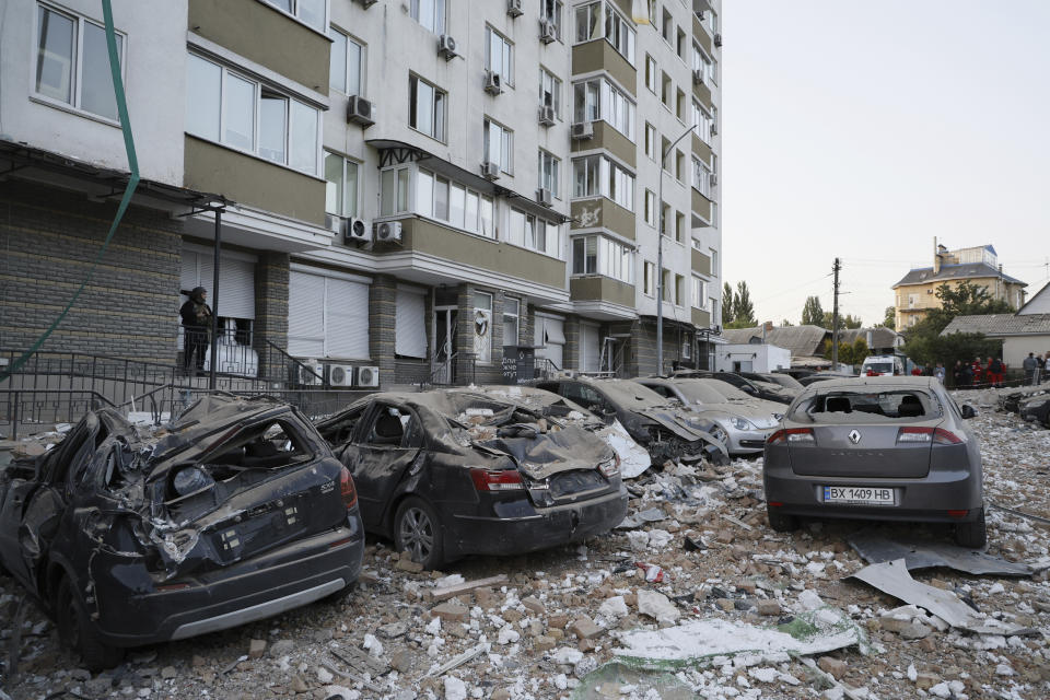 Damaged cars are parked in the yard of a multi-story apartment building which was damaged in a relentless wave of bombardments targeting in Kyiv, Ukraine, Tuesday, May 30, 2023. (AP Photo/Alex Babenko)