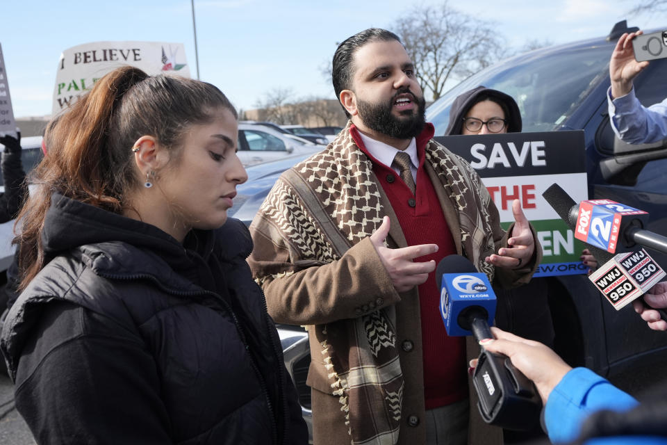 Imran Salha, center, imam of the Islamic Center of Detroit, and Lexis Zeidan, left, address the media before joining about three dozen people protesting Israel's attacks in Gaza, Thursday, Feb. 8, 2024 in Dearborn, Mich. The protesters gathered hoping to be heard by members of the Biden White House who were scheduled to meet in suburban Detroit with Muslim and Arab American leaders. (AP Photo/Carlos Osorio)