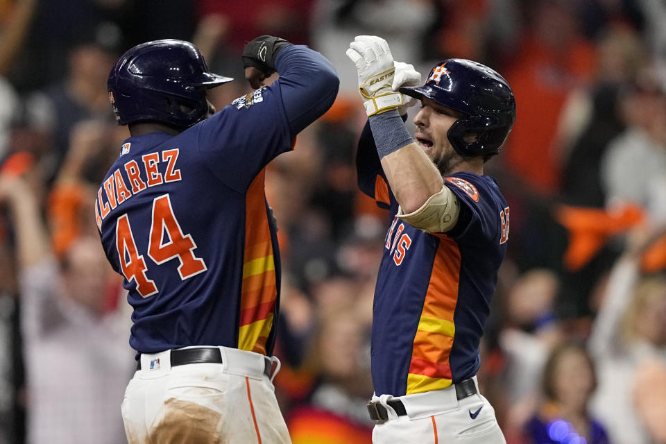 Houston Astros' Alex Bregman celebrates his two-run homerun with Yordan Alvarez during the fifth inning in Game 2 of baseball's World Series between the Houston Astros and the Philadelphia Phillies on Saturday, Oct. 29, 2022, in Houston. (AP Photo/David J. Phillip)