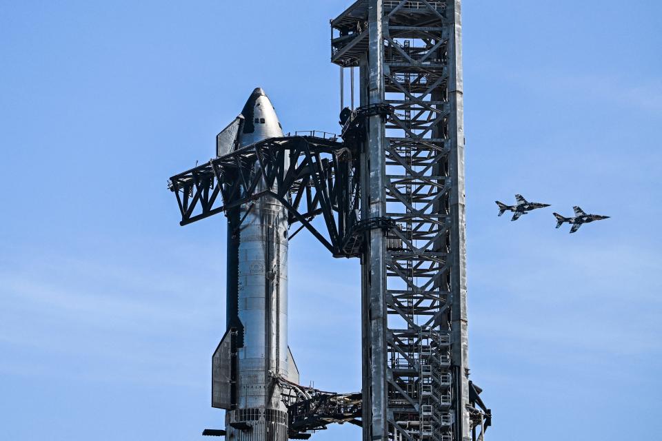 The SpaceX Starship spacecraft can be seen on Wednesday as jets fly by in the background. SpaceX will conduct the third test flight of the Starship rocket Thursday morning from Starbase in Boca Chica, Texas. Two previous tests have ended in explosions.