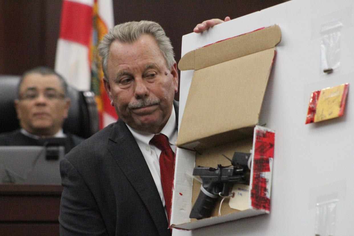 7th Circuit State Attorney R.J. Larizza shows jurors Tuesday the Glock 17 prosecutors say Othal Wallace used to kill Daytona Beach police officer Jason Raynor.