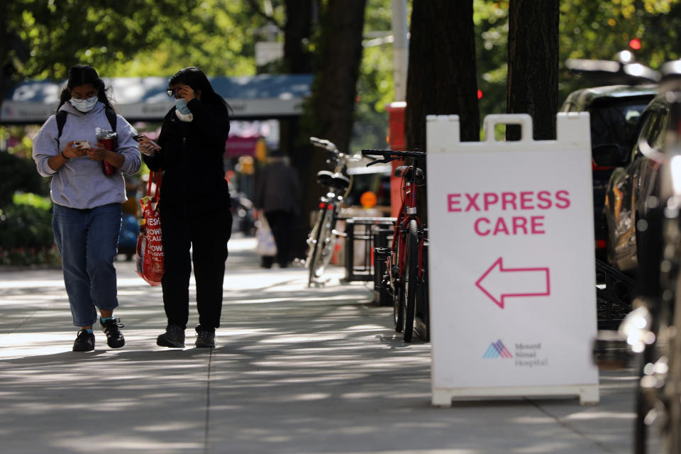 NEW YORK, NEW YORK - SEPTEMBER 22: People walk past an "Express Care" sign at Mount Sinai Hospital in Manhattan, which has treated hundreds of COVID-19 patients since March, on September 22, 2020 in New York City. While New York’s infection rate is currently below one percent,  the U.S. has reported more than 6.7 million confirmed cases and 200,000 deaths attributed to COVID-19, making it the world leader in both. (Photo by Spencer Platt/Getty Images)