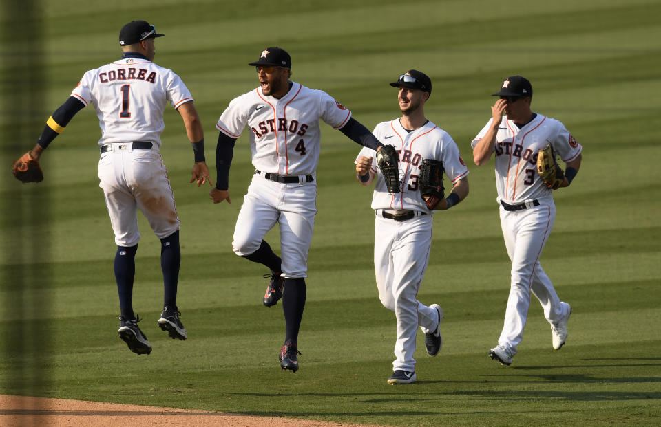 LOS ANGELES, CALIFORNIA - OCTOBER 08: Carlos Correa #1, George Springer #4,  Kyle Tucker #30 and Myles Straw #3 of the Houston Astros celebrate a series win against the Oakland Athletics  in Game Four of the American League Division Series at Dodger Stadium on October 08, 2020 in Los Angeles, California. (Photo by Harry How/Getty Images)