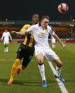 Manchester United's Phil Jones (R) is challenged by Cambridge United's Tom Elliott during their English FA Cup 4th round soccer match at The Abbey Stadium in Cambridge, eastern England January 23, 2015. REUTERS/Andrew Winning (BRITAIN - Tags: SPORT SOCCER)