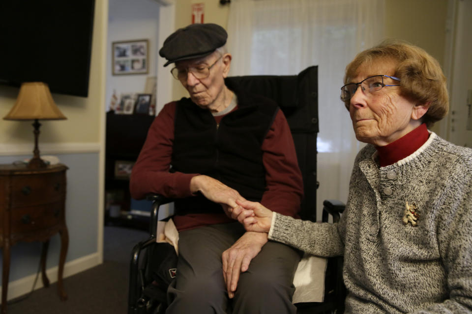 In this photo taken Thursday, Dec. 5, 2019, Betty Briggs sits with her husband Bob, who has Alzheimer's disease, as she recalls the recent power blackouts at the Cedars Care Home in Calistoga, Calif. Even before widespread blackouts hit California this fall, the utility that triggered them showed signs it wasn’t fully prepared. An Associated Press review reveals persistent problems during four smaller shutoffs that Pacific Gas & Electric did starting last year so power lines downed by strong winds wouldn’t spark wildfires. (AP Photo/Eric Risberg)