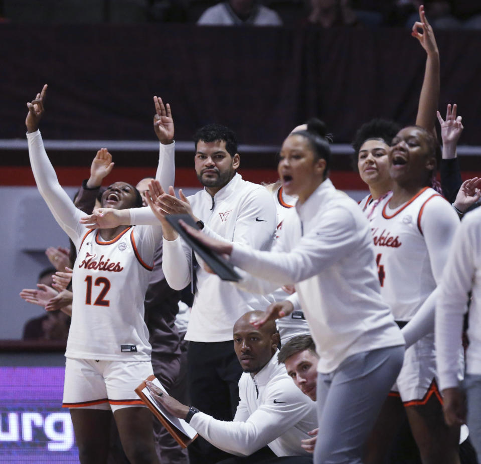 The Virginia Tech bench celebrates a 3-point basket by Cayla King in the first half of an NCAA college basketball game against Clemson in Blacksburg, Va, Sunday, Jan. 21, 2024. (Matt Gentry/The Roanoke Times via AP)