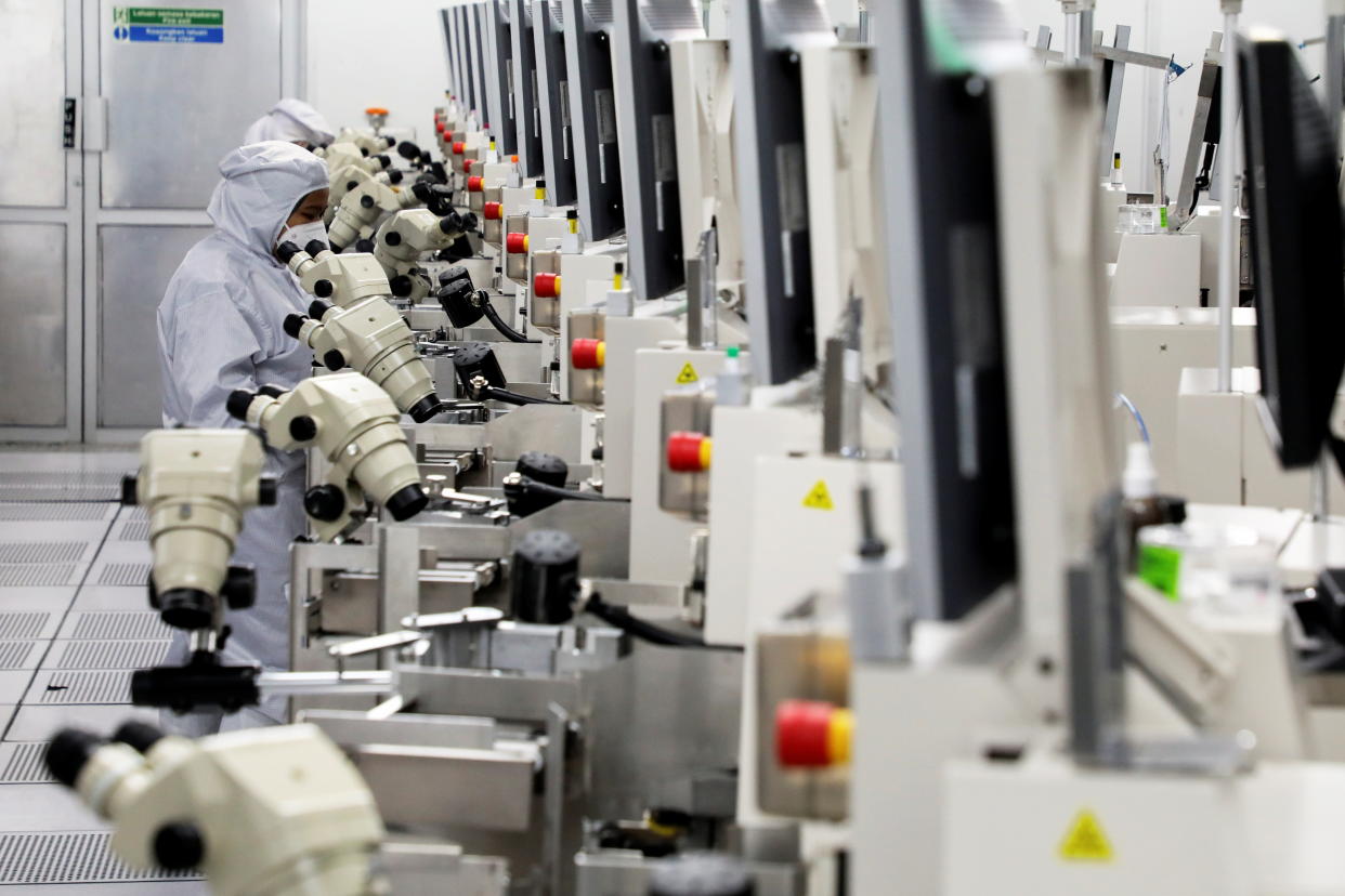 Workers monitor operations at the chip packaging firm Unisem (M) Berhad plant in Ipoh, Malaysia October 15, 2021. REUTERS/Lim Huey Teng