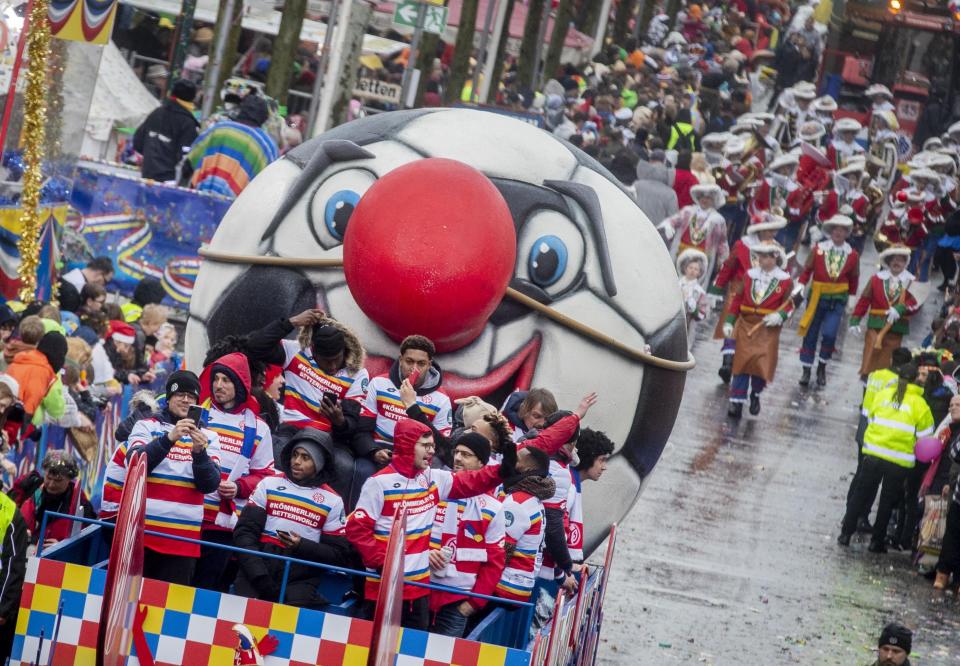 Soccer players of FSV Mainz 05 take part in the traditional carnival parade in Mainz, Germany Monday, Feb. 24, 2020. (AP Photo/Michael Probst)