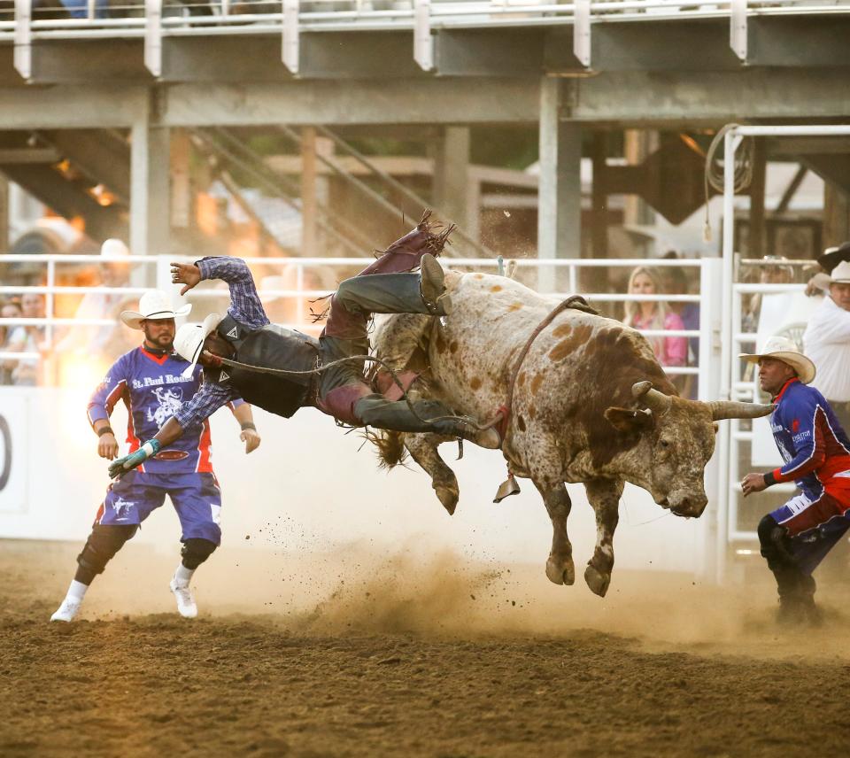 Christopher Byrd of Compton, Calif., competes Friday in bull riding at the St. Paul Rodeo.