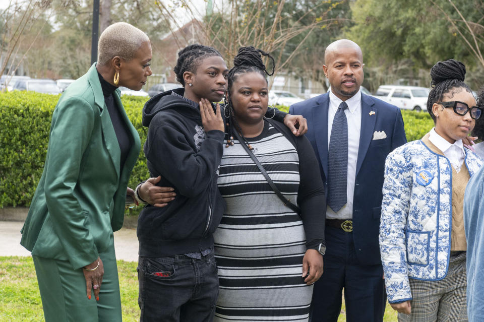 Darryl George, center, hugs his mother Darresha, as they wait with state representative Jolanda Jones, left, and state representative Ron Reynolds, right, before a hearing regarding George's punishment for violating school dress code policy because of his hair style, Thursday Feb. 22, 2024 at the Chambers County Courthouse in Anahuac, Texas. A judge has ruled that George's monthslong punishment by his Texas school district for refusing to change his hairstyle does not violate a new state law prohibiting race-based hair discrimination. (Kirk Sides/Houston Chronicle via AP)