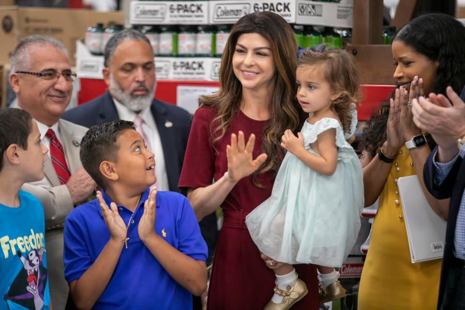 Vincent Soto, 10, applauds as Florida first lady Casey DeSantis waves Friday morning during a press conference in Ocala.