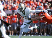 STILLWATER, OK - OCTOBER 29: Quarterback Robert Griffin III #10 of the Baylor Bears is grabbed by defensive end Cooper Bassett #80 of Oklahoma State Cowboys in the first half October 29, 2011 at Boone Pickens Stadium in Stillwater, Oklahoma. Oklahoma State leads Baylor 35-0 at the half. (Photo by Brett Deering/Getty Images)