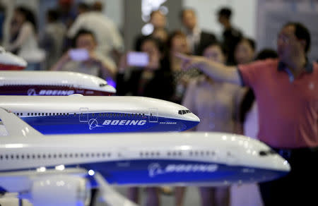 FILE PHOTO: Visitors look at models of Boeing aircrafts at the Aviation Expo China 2015, in Beijing, China, in this September 16, 2015 file photo. REUTERS/Jason Lee/File Photo