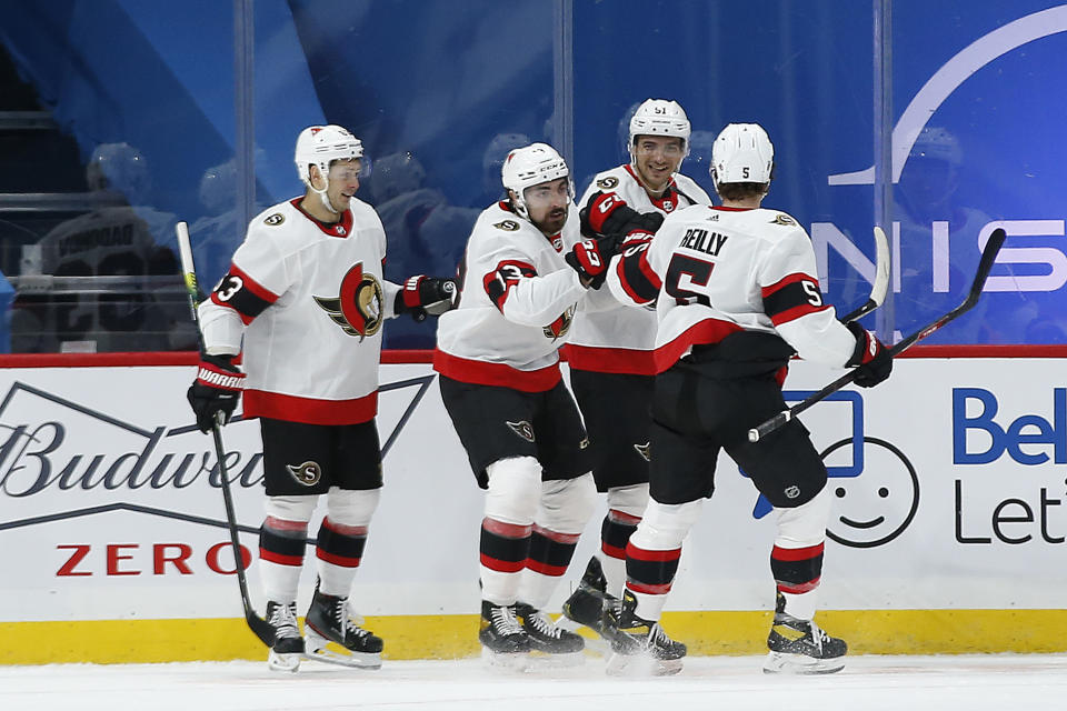 Ottawa Senators' Evgenii Dadonov (63), Nick Paul (13), Artem Anisimov (51) and Mike Reilly (5) celebrate Paul's goal against the Winnipeg Jets during the second period of an NHL hockey game Saturday, Jan. 23, 2021, in Winnipeg, Manitoba. (John Woods/The Canadian Press via AP)