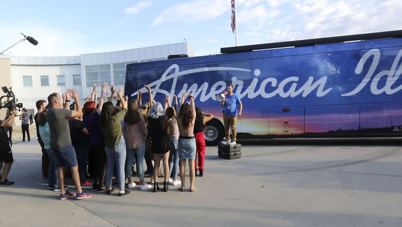 Collin DeClerk, production assistant, tries to get the crowd excited while filming before “American Idol” auditions outside of the Northwest Community Center in Salt Lake City on Thursday, Aug. 29, 2019. The show is holding virtual auditions for the fourth year in a row. 