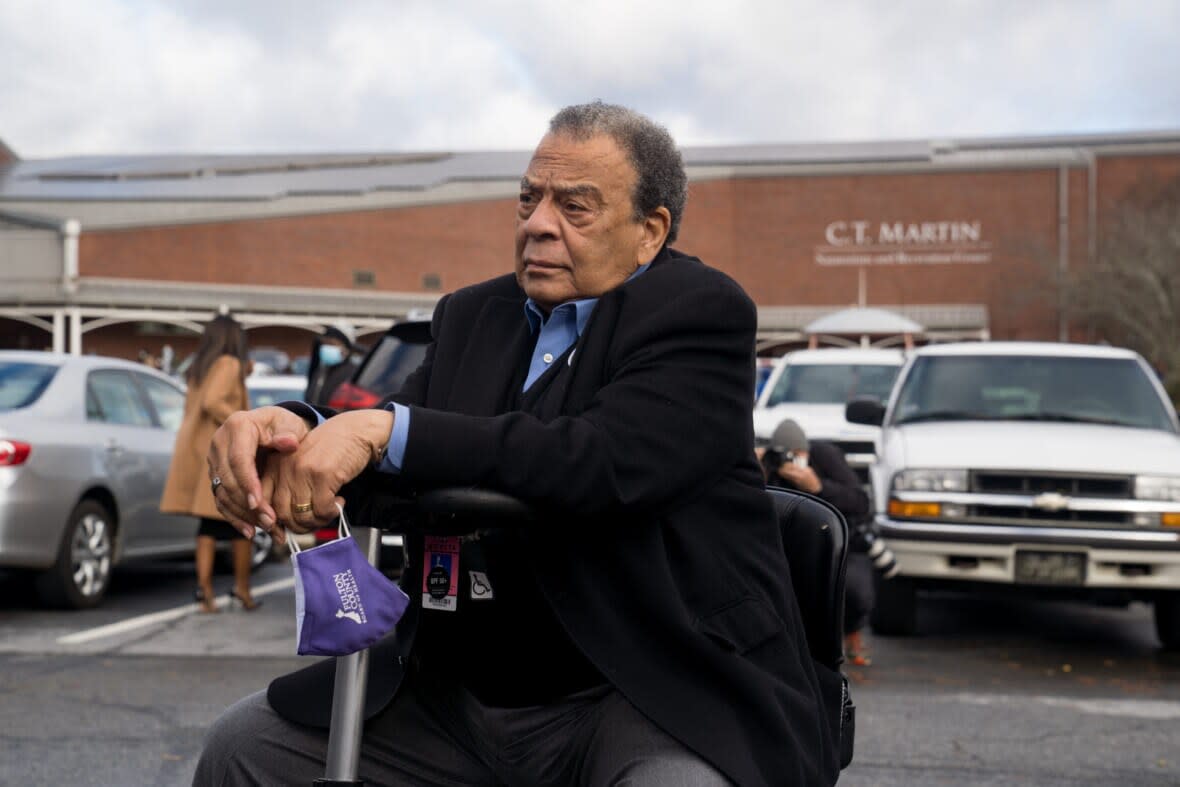 Former Atlanta mayor and U.N. Ambassador Andrew Young listens while Democratic nominee for U.S. Senate Rev. Raphael Warnock speaks after casting his vote in the runoff election on the first day of early voting on December 14, 2020 in Atlanta, Georgia. (R-GA). (Photo by Megan Varner/Getty Images)