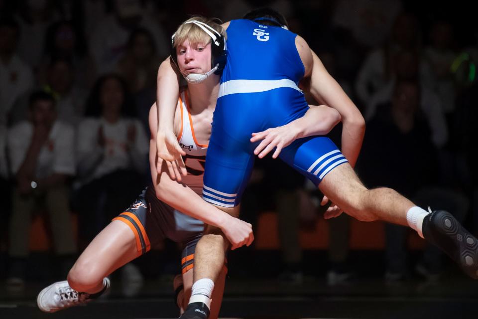 Central York's Carter Davis (left) won the 152-pound title at the District 3 Class 3A Section IV championships.
