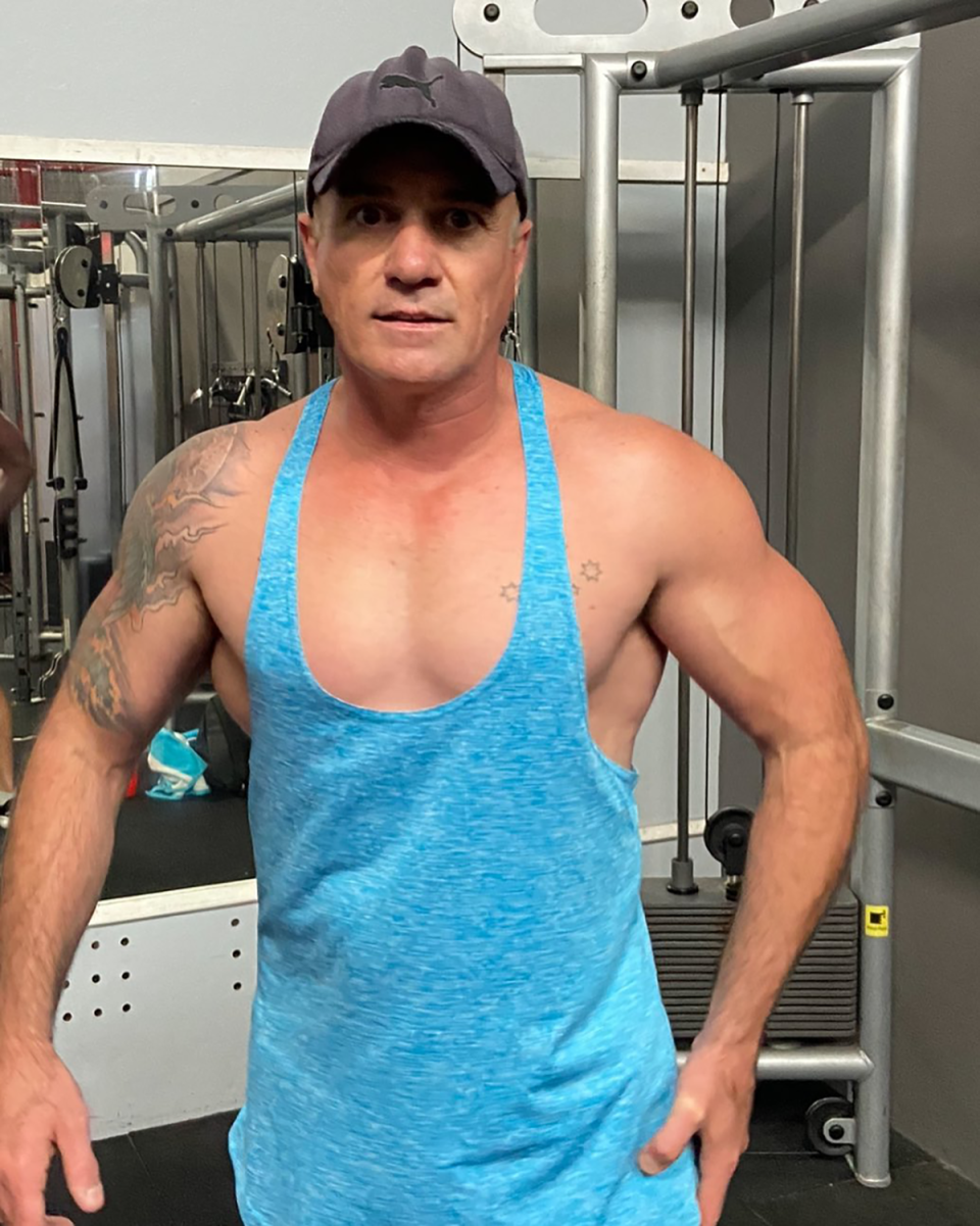 Shannon Noll wearing a thin blue singlet at the gym.