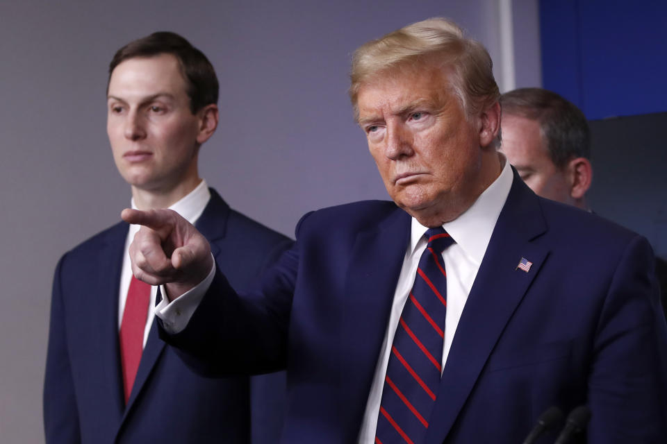 President Donald Trump points to a reporter to ask a question as he speaks about the coronavirus in the James Brady Press Briefing Room of the White House, Thursday, April 2, 2020, in Washington, as White House adviser Jared Kushner listens. (AP Photo/Alex Brandon)