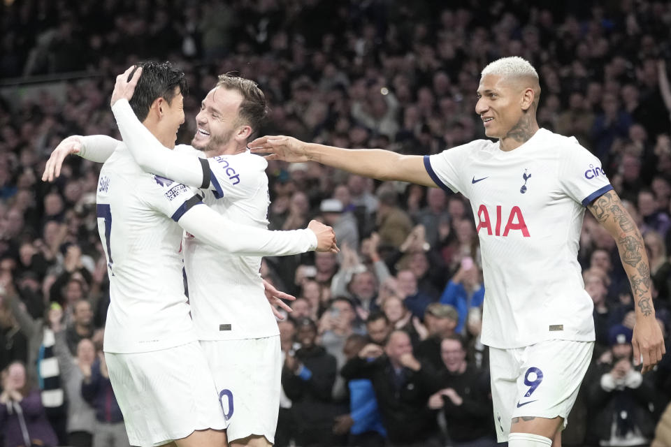 Tottenham's James Maddison, centre, celebrates with Tottenham's Son Heung-min, left, Tottenham's Richarlison, right, after scoring his side's second goal during the English Premier League soccer match between Tottenham Hotspur and Fulham at the Tottenham Hotspur Stadium in London, Monday, Oct. 23, 2023. (AP Photo/Kin Cheung)