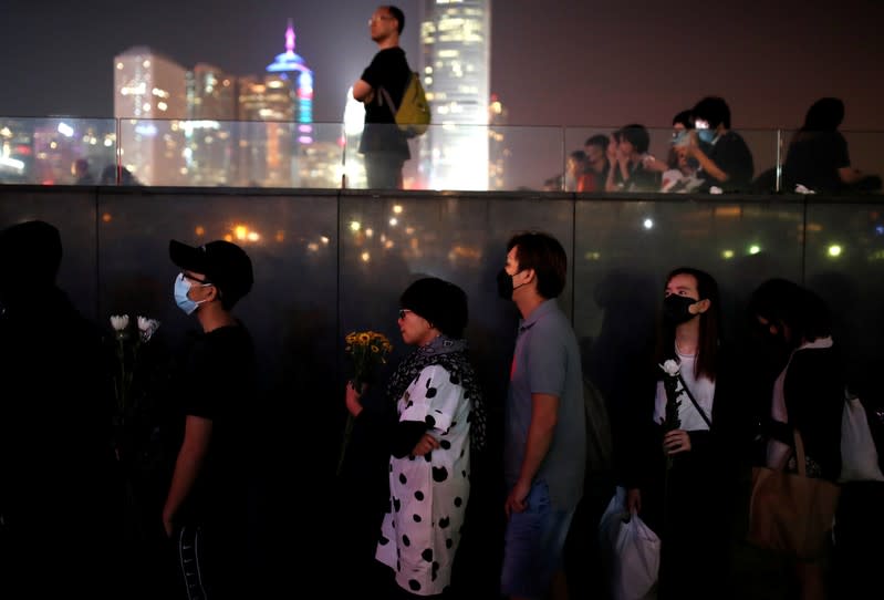People line up to pay tribute at Tamar Park, outside the Legislative Council (Legco) building, during a prayer and remembrance ceremony in Hong Kong