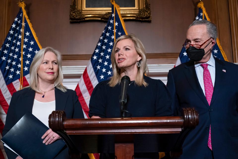 Former Fox News anchor Gretchen Carlson, center, joins Sen. Kirsten Gillibrand, D-N.Y., left, and Senate Majority Leader Chuck Schumer, D-N.Y., after Congress gave final approval to legislation guaranteeing that people who experience sexual harassment at work can seek recourse in the courts, during a news conference at the Capitol in Washington, Thursday, Feb. 10, 2022. Since her 2016 sexual harassment lawsuit against then Fox News Chairman and CEO Roger Ailes, Carlson has worked to ban non-disclosure agreements and forced arbitration clauses in employment agreements to prevent victims of sexual harassment from being silenced.
