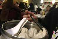 A customer helps himself to a soup dumpling at a Chinese dim sum restaurant on Friday Jan. 10, 2020, in New York City. A social media campaign backed by a Japanese seasonings company is targeting the persistent idea that Chinese food is packed with MSG and can make you sick. So entrenched is the notion in American culture, it shows up in the dictionary: Merriam-Webster.com lists “Chinese restaurant syndrome." as a real illness. But much of the mythology around the idea has been debunked: monosodium glutamate, also known as MSG, shows up in many foods from tomatoes to breast milk, and there's no evidence to link it to illness. (AP Photo/Wong Maye-E)