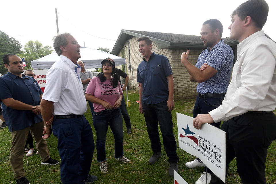 Texas State House District 21 candidate David Covey and supporters talk with Texas Attorney General Ken Paxton, who made a poll stop at the Raymond Gould Community Center in Vidor, Texas, Tuesday, May 28, 2024. (Kim Brent/The Beaumont Enterprise via AP)