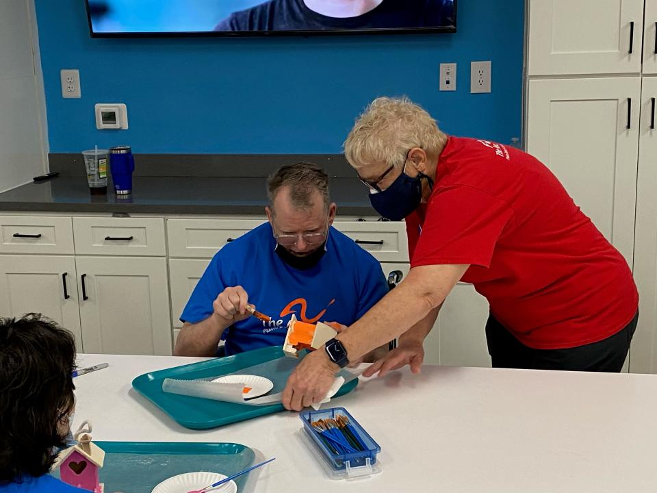 A staff member helps a client Wednesday at The Arc of Palm Beach County's new 15,000 square foot habilitation center in Riviera Beach for the developmentally disabled.