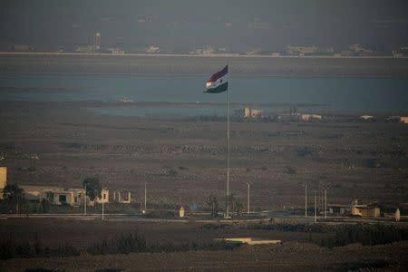 A Syrian flag flutters on a pole near the Quneitra crossing in Syria close to the border fence with the Israeli-occupied Golan Heights September 1, 2014. REUTERS/Baz Ratner