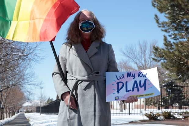 A woman demonstrates against a proposed ban on transgender girls and women from female sports leagues in South Dakota in March. Republican lawmakers in several U.S. states have introduced legislature related to transgender issues. (Stephen Groves/The Associated Press - image credit)