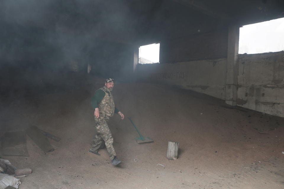 Andrii, a serviceman of the Ukrainian Armed Forces volunteer unit Karpatska Sich, walks inside a grain storage of a farmer enterprise, damaged during a Russian military strike, as Russia's attack on Ukraine continues, in Kharkiv region, Ukraine May 2, 2022.  REUTERS/Serhii Nuzhnenko