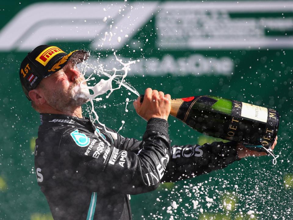 Mercedes' Finnish driver Valtteri Bottas celebrates with champagne: POOL/AFP via Getty Images