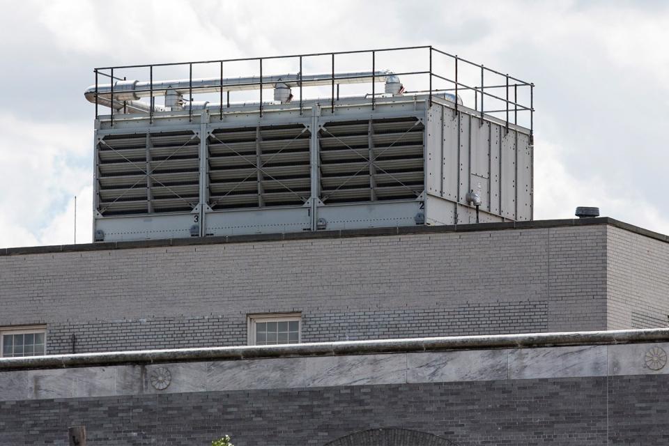 NEW YORK, NY - AUGUST 13: A water cooling tower that was found to have traces of legionella pneumophila bacteria, which may have helped cause the recent outbreak of Legionnaires' disease in the Bronx, is seen on top of the United States Post Office at 558 Grand Concourse, on August 13, 2015 in the Bronx borough of New York City. In a press conference today New York City Mayor Bill de Blasio said that while new cases of Legionnaires' may appear, the outbreak has been contained and that the water cooling towers the New York City Department of Health believe are responsible for the outbreak have been decontaminated. (Photo by Andrew Burton/Getty Images)