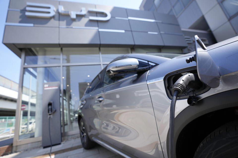 A BYD ATTO 3 electric sports utility vehicle gets charged as it is displayed at a BYD dealership on April 4, 2023, in Yokohama near Tokyo. BYD Auto is part of a wave of Chinese electric car exporters that are starting to compete with Western and Japanese brands in their home markets. They bring fast-developing technology and low prices that Tesla Inc.'s chief financial officer says “are scary.” (AP Photo/Eugene Hoshiko)