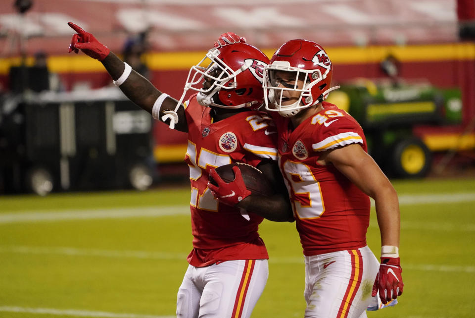 Kansas City Chiefs cornerback Rashad Fenton (27) celebrates with teammate Daniel Sorensen (49) after intercepting a pass during the second half of an NFL football game against the New England Patriots, Monday, Oct. 5, 2020, in Kansas City. (AP Photo/Jeff Roberson)