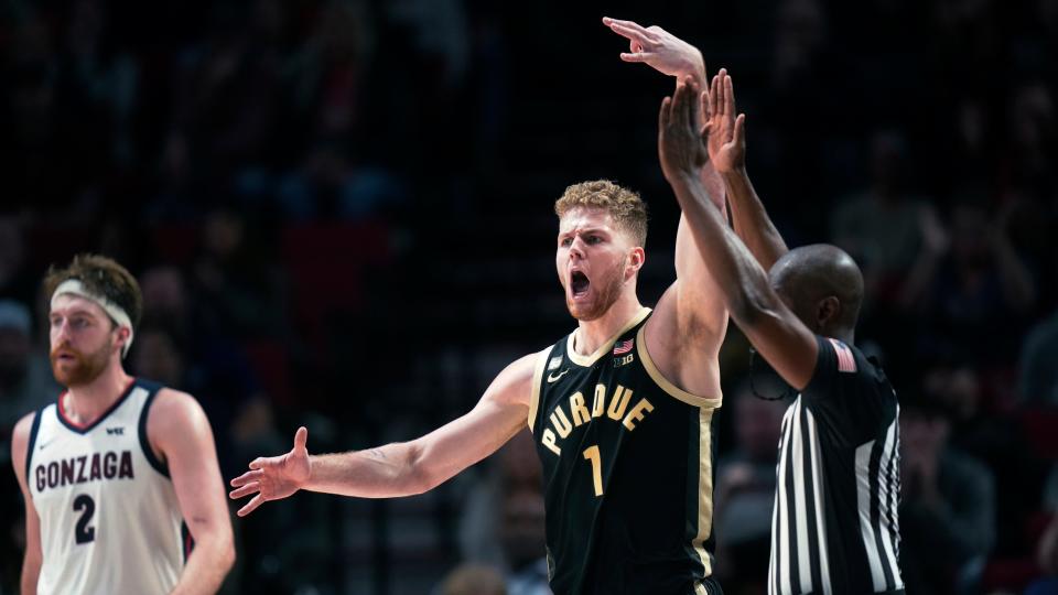 Purdue forward Caleb Furst (1) reacts after scoring a 3-pointer, as Gonzaga forward Drew Timme (2) as walks up the court during the second half of an NCAA college basketball game in the Phil Knight Legacy tournament Friday, Nov. 25, 2022, in Portland, Ore. (AP Photo/Rick Bowmer)