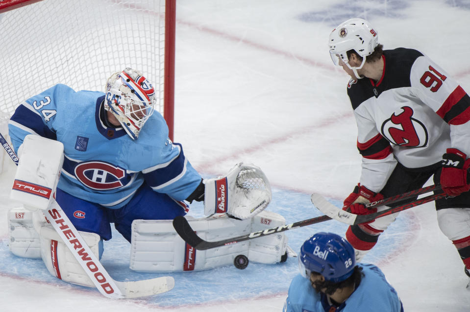 New Jersey Devils' Dawson Mercer (91) moves in on Montreal Canadiens goaltender Jake Allen during the second period of an NHL hockey game, Tuesday, Nov. 15, 2022 in Montreal. (Graham Hughes/The Canadian Press via AP)