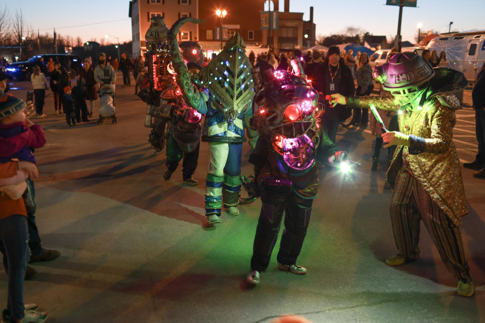 HOULTON, MAINE - APRIL 07: People dressed as alien creatures walk through the main square during an eclipse festival on April 07, 2024, in Houlton, Maine. Millions of people have flocked to areas across North America that are in the 