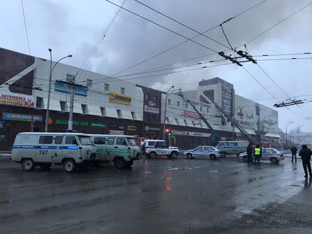 Rescue personnel is seen on a site of fire at a shopping mall in Kemerovo, Russia March 25, 2018. REUTERS/Dmitry Saturin