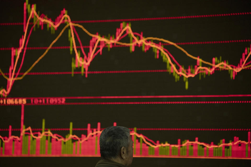 In this Thursday, Dec. 12, 2019, photo, an investor monitors stock prices at a brokerage in Beijing. Shares likewise jumped Friday, Dec. 13, 2019 in Asia following fresh all-time highs overnight on Wall Street spurred by optimism that the U.S. and China are close to reaching a deal to end their costly trade war. (AP Photo/Ng Han Guan)