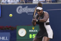 Serena Williams, of the United States, his a backhand to Belinda Bencic, of Switzerland, during the National Bank Open tennis tournament Wednesday, Aug. 10, 2022, in Toronto. (Nathan Denette/The Canadian Press via AP)