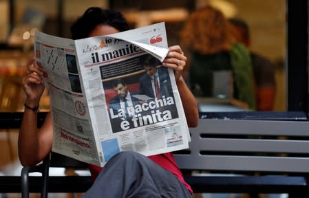 A woman reads a newspaper with news of Government crisis and the resignation of the prime minister Giuseppe Conte.